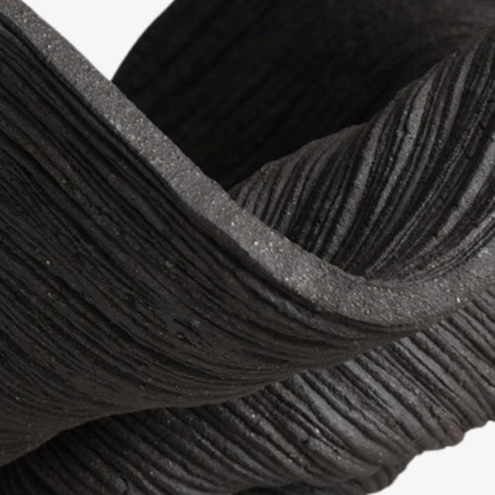 Close-up of a black coiled porcelain small bowl showing its textured surface with horizontal grooves