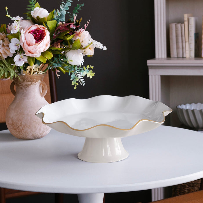 Beatriz Ball Encanto Carola Pedestal Cake Plate — Empty stand beside a floral arrangement