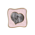 Beatriz Ball Frame Encanto Curved Heart 5 x 5 — Camellia pink heart-opening frame with an illustrative photograph