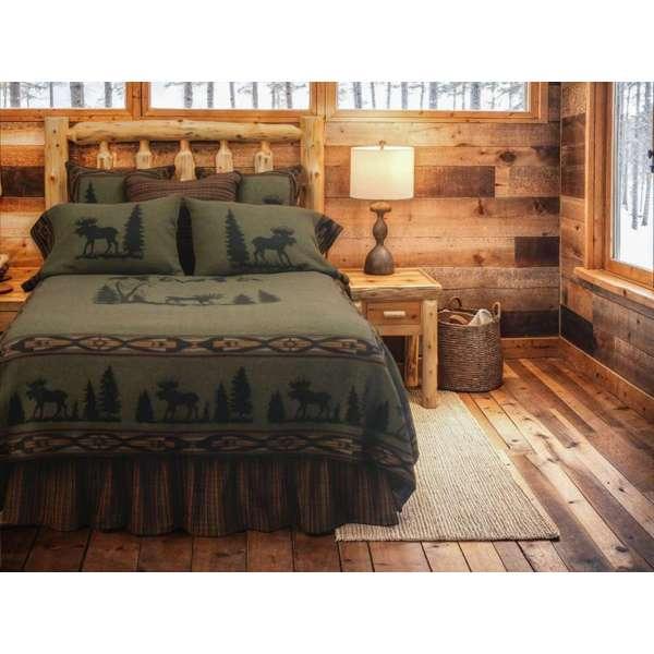 Bedroom with wooden walls and floor, featuring a bed with moose-themed bedding - Your Western Decor