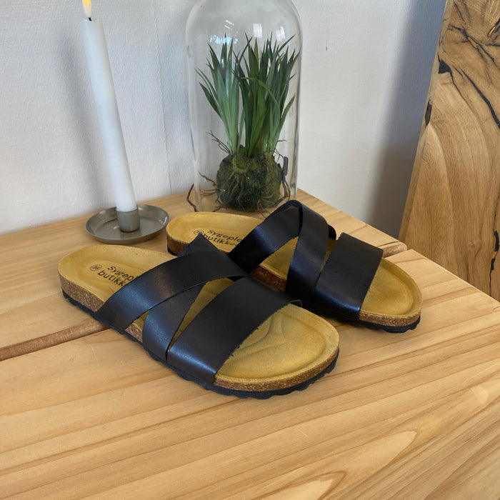 Slip-on sandal i svart slätt läder med korsremmar – komfort och stöd